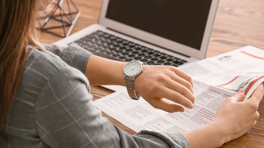 Woman looking at watch to see the time.