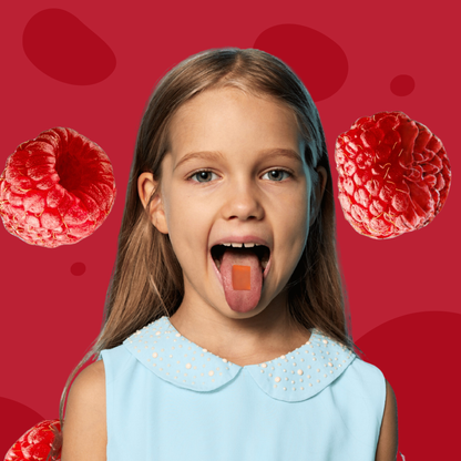 Young girl with a dissolvable vitamin strip on her tongue against a red background with raspberries